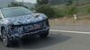 Mahindra-BE-6e-spied-testing-on-road-for-the-first-time.-Flush-door-handles-visible-under-a-blue-camouflage